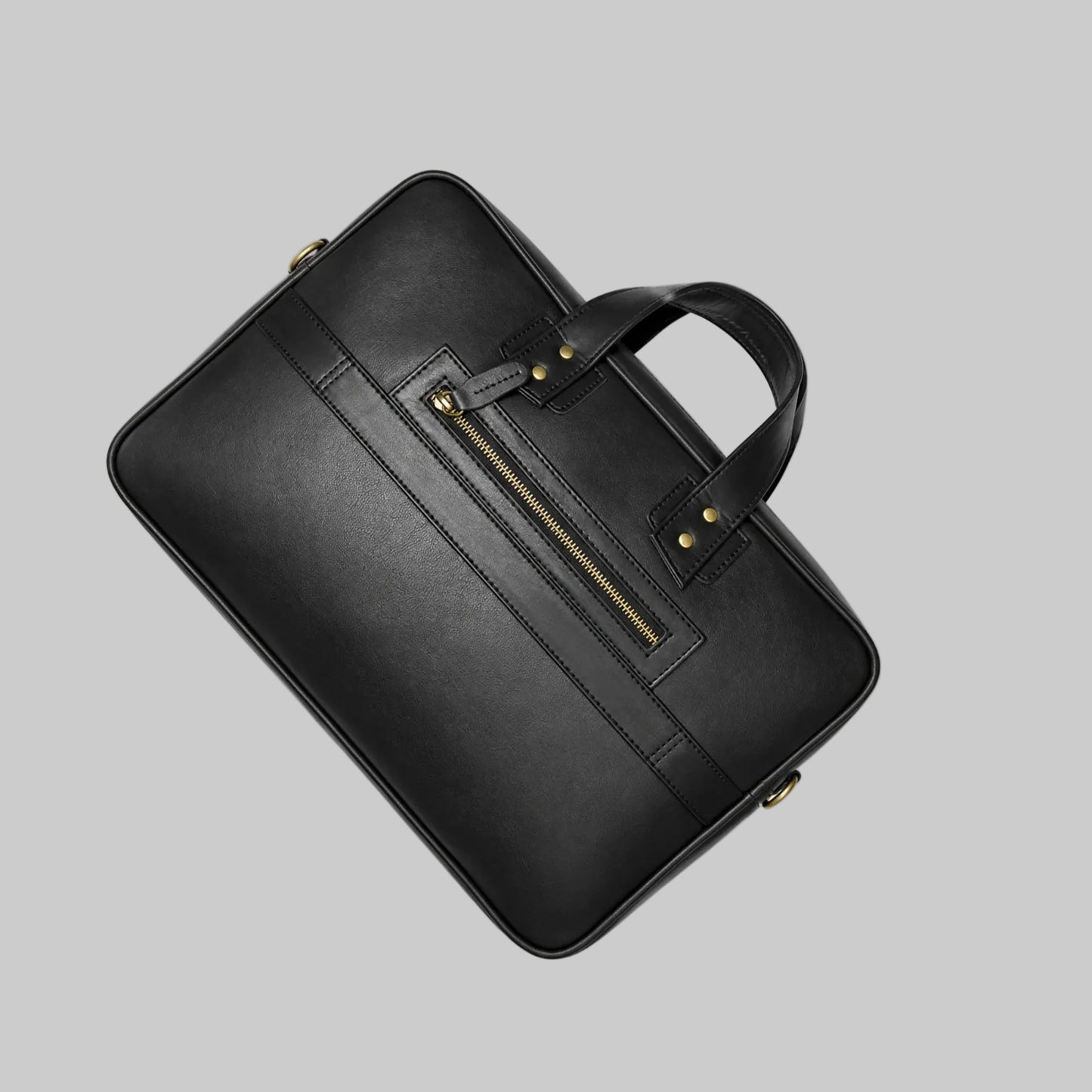 Black leather briefcase with gold zipper on a white background