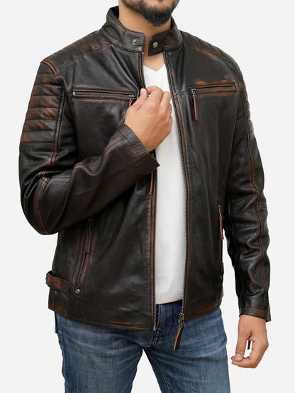 Man wearing a brown leather jacket over a white shirt with a plain background