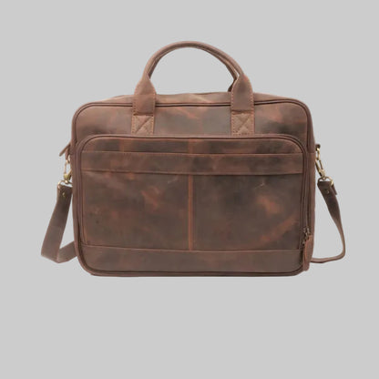 Brown leather briefcase with shoulder strap on a white background