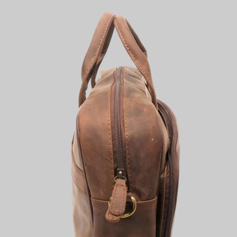 Brown leather bag with a gold zipper on a white background