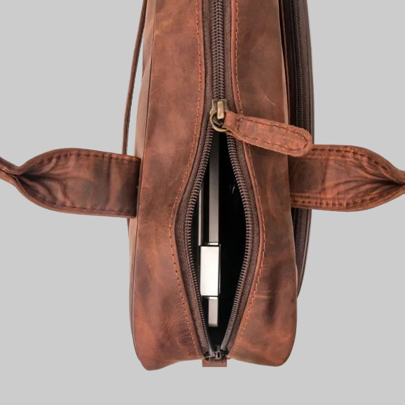 Brown leather bag with a zipper on a white background