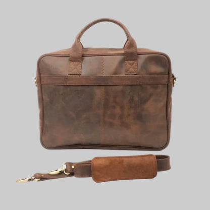 Brown leather briefcase with strap on a white background