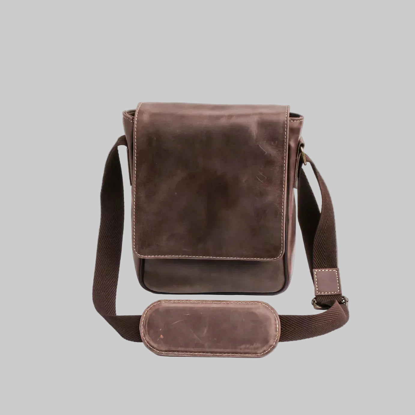 Brown leather crossbody bag on a white background
