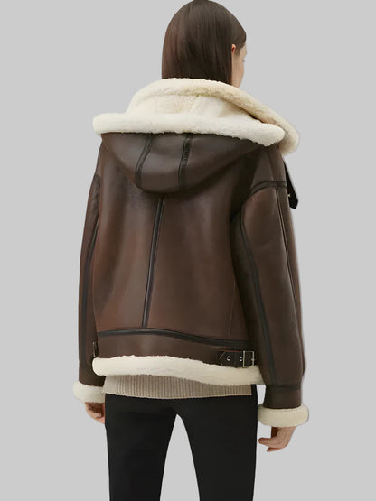 Brown leather jacket with white fur lining on a gray background