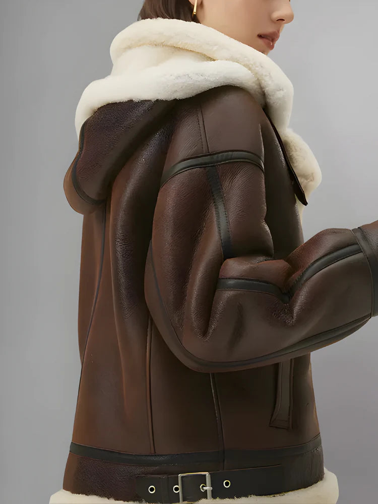 Brown leather jacket with white fur lining on a gray background
