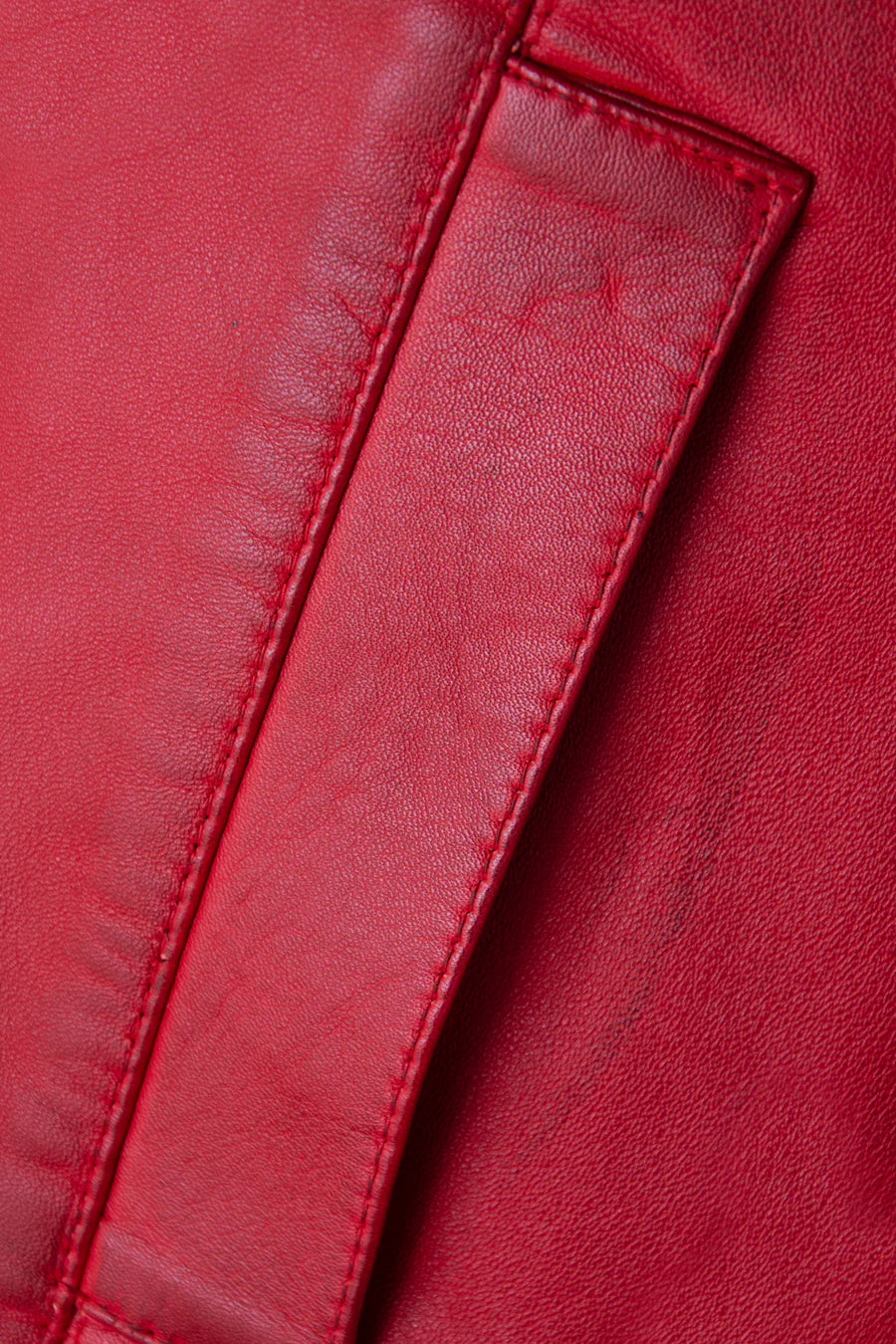 Close-up of a red leather jacket with stitching detail