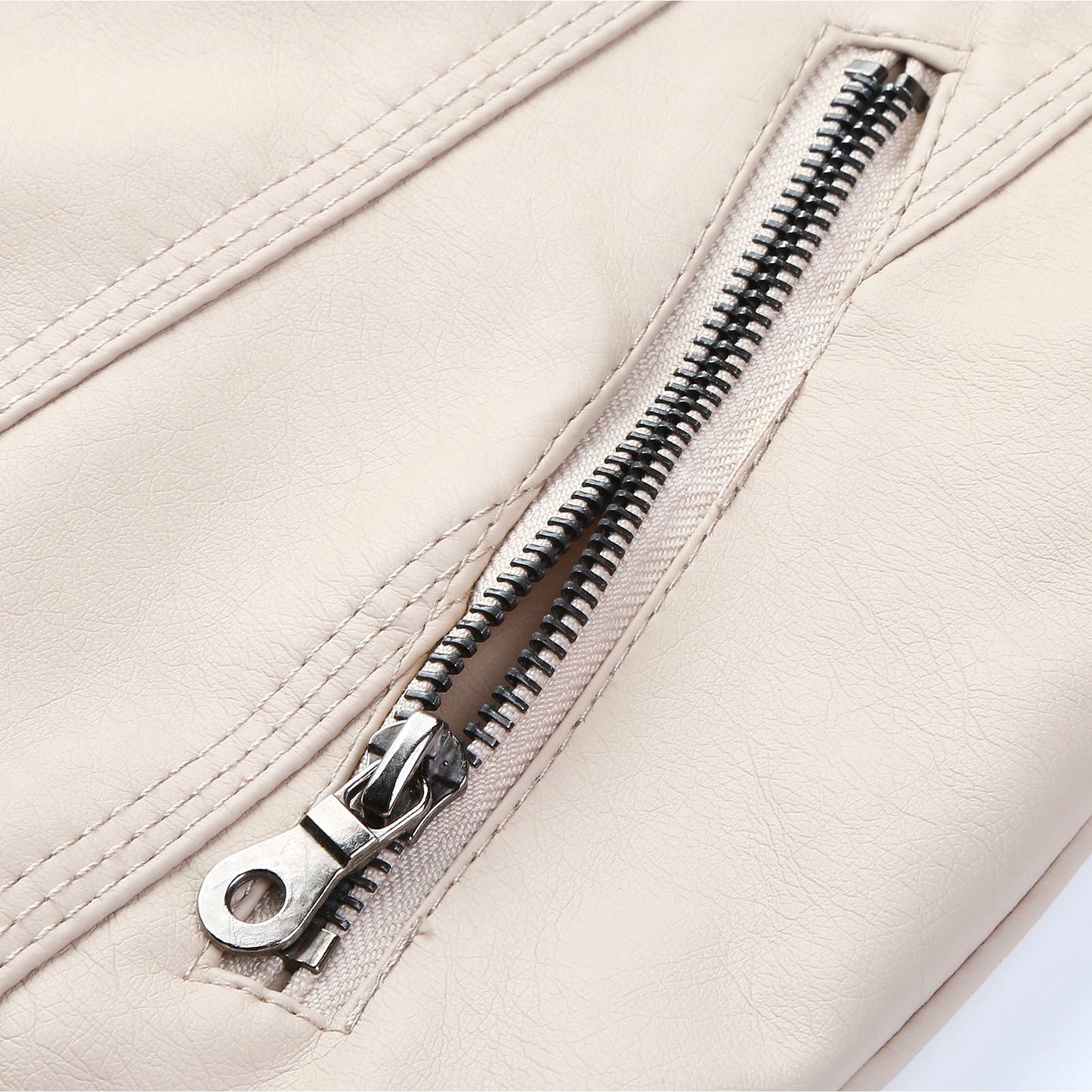 Close-up of a zipper on a beige jacket