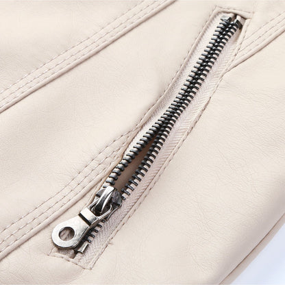Close-up of a zipper on a beige jacket