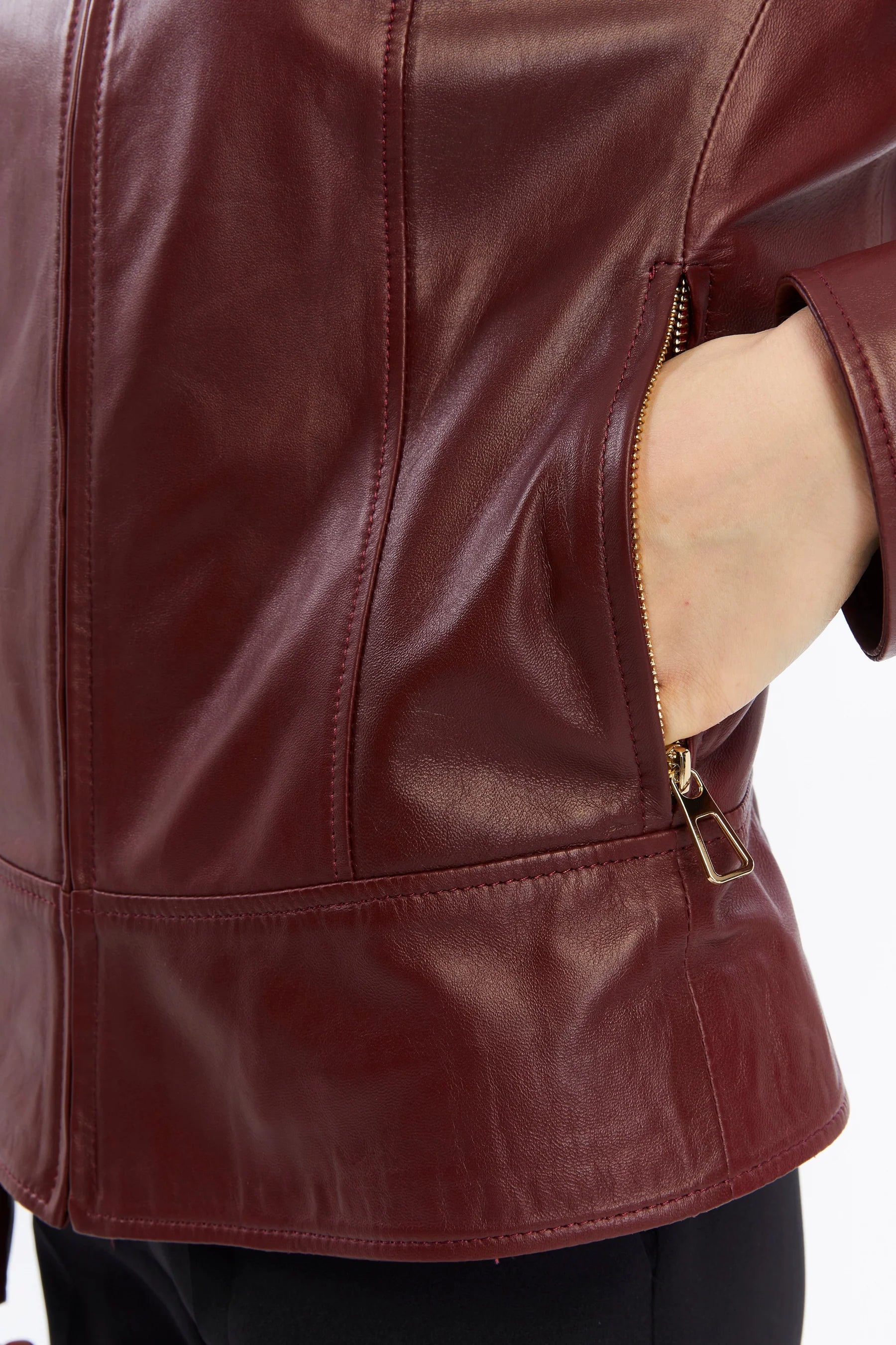 Close-up of a maroon leather jacket with a zipper on a white background