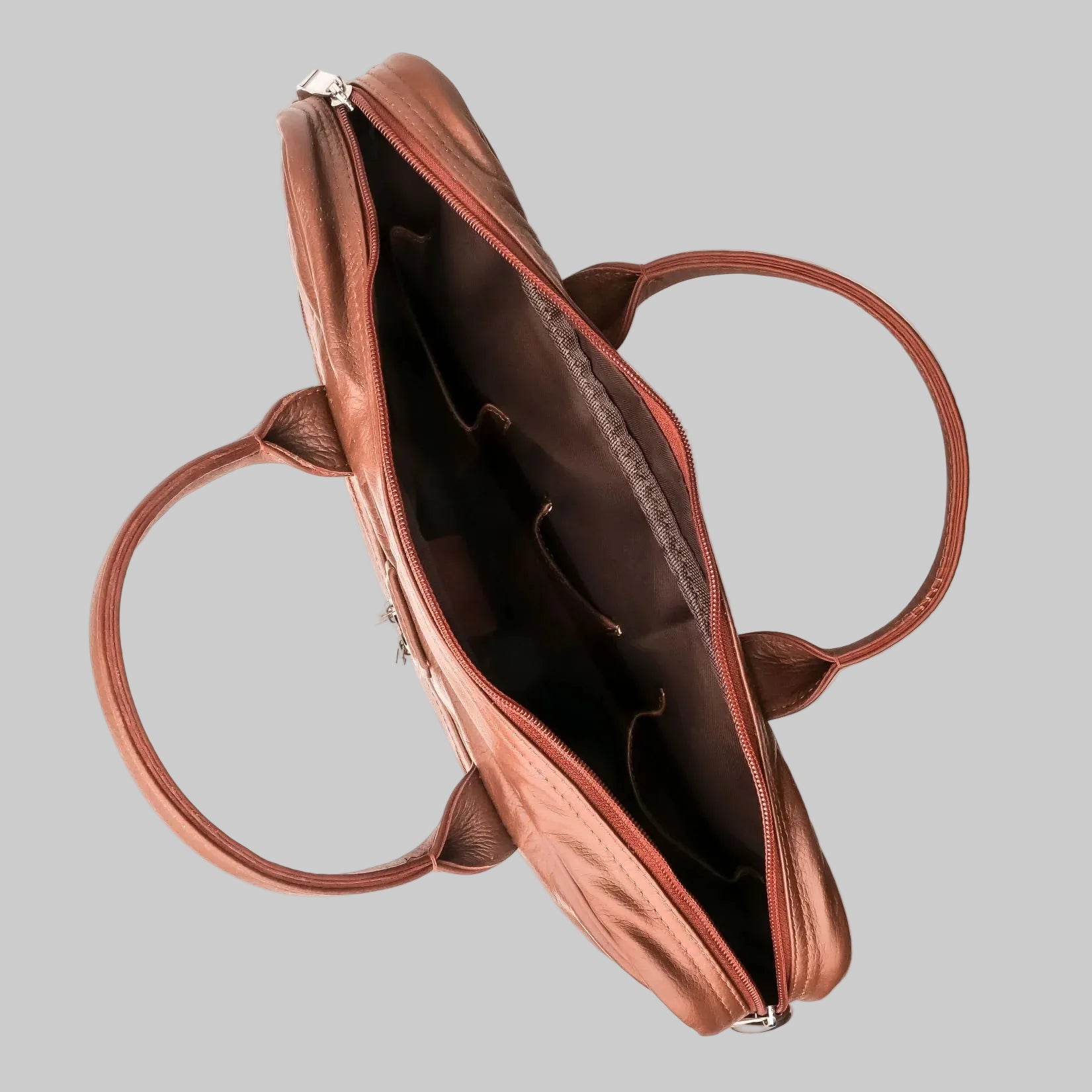 Brown leather handbag with open top on a white background