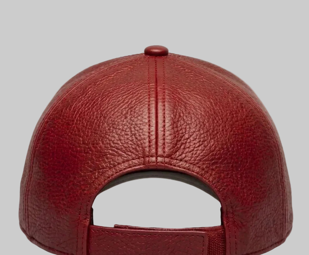 Red leather baseball cap on a light gray background