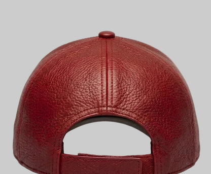 Red leather baseball cap on a light gray background