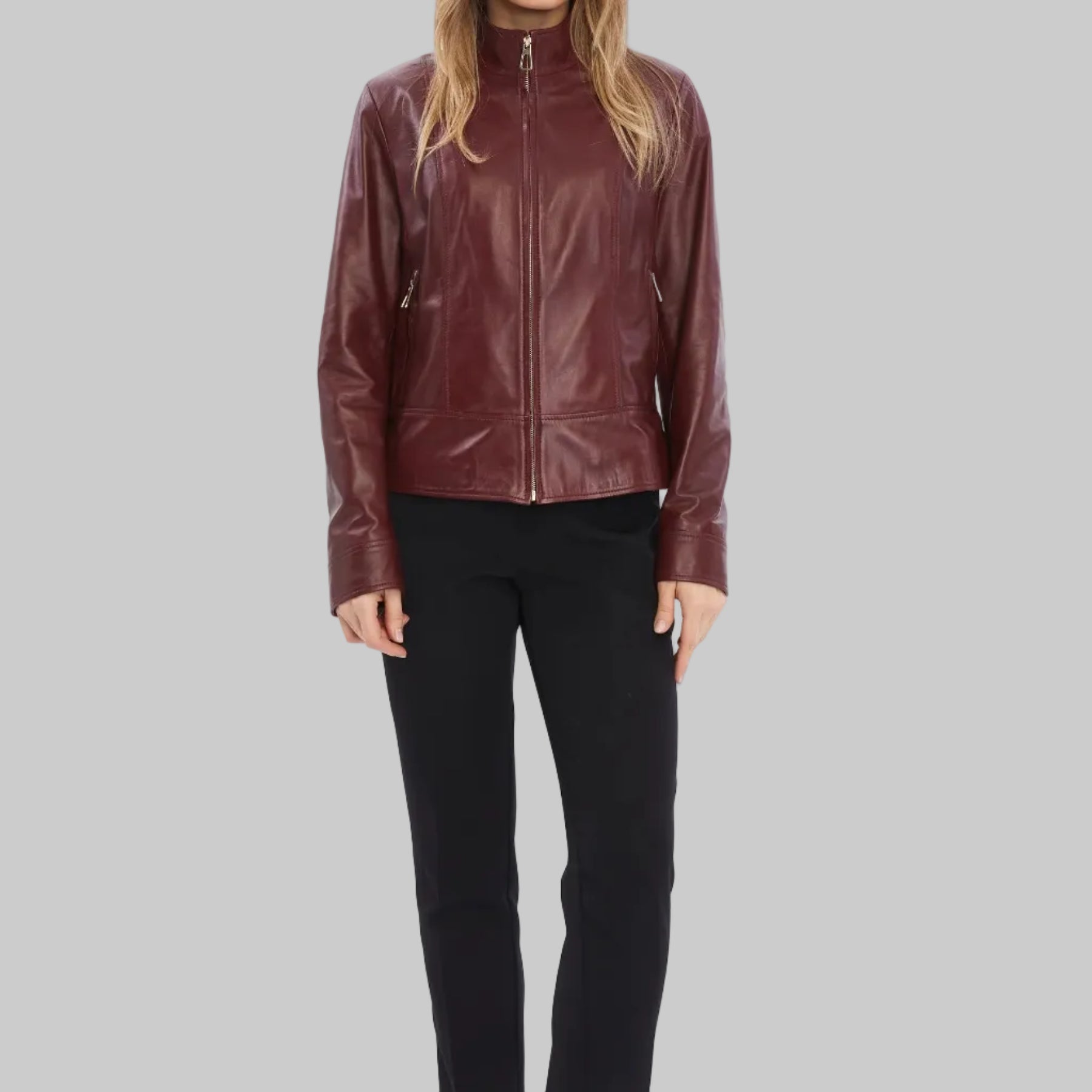 Woman wearing a brown leather jacket on a white background