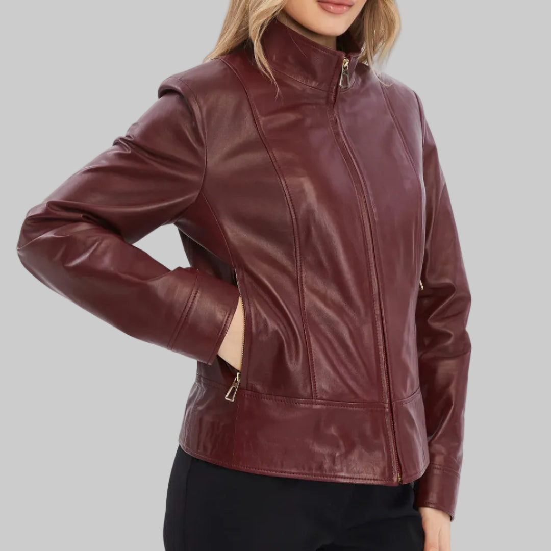 Woman wearing a burgundy leather jacket on a white background