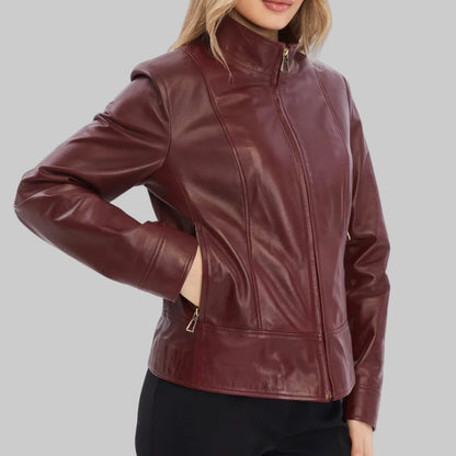 Woman wearing a burgundy leather jacket on a white background