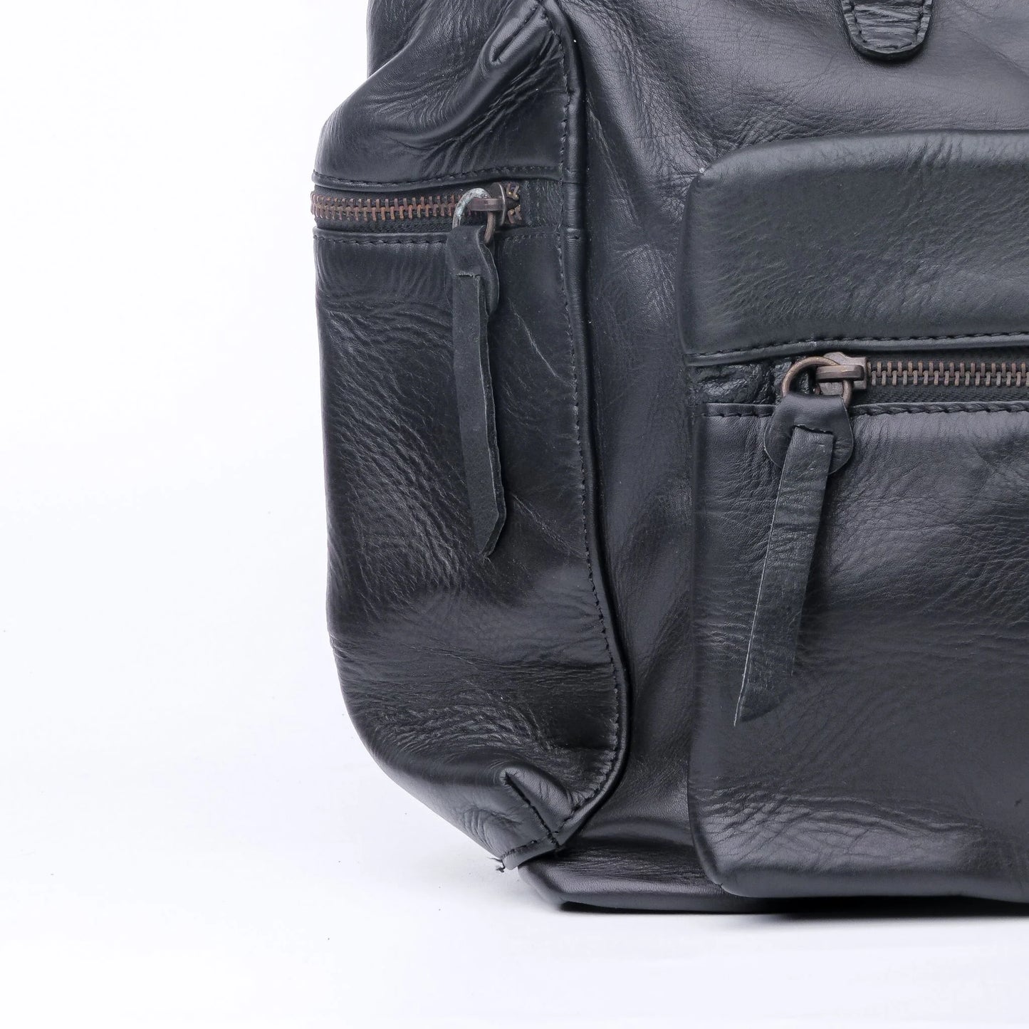 Black leather backpack with zippers on a white background
