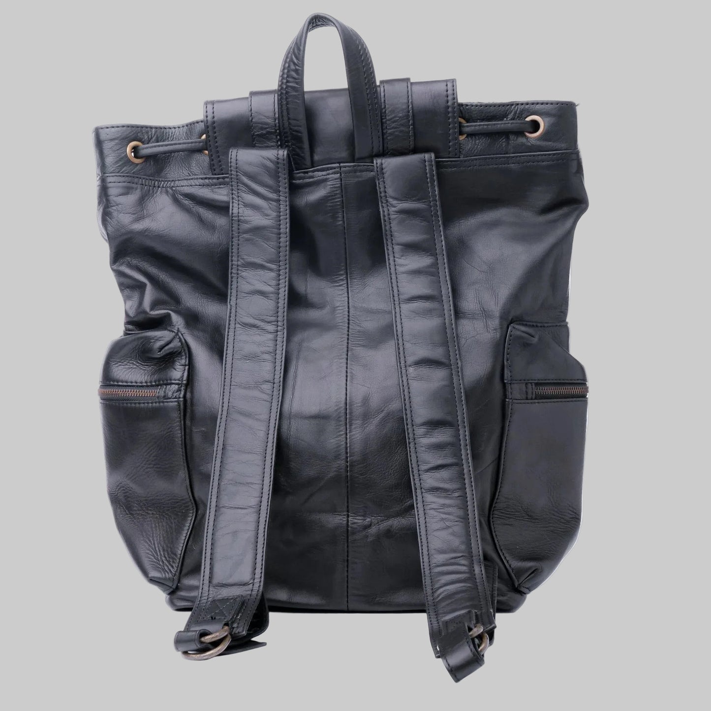 Black leather backpack shown from the back, featuring dual top handles, side pockets, and padded shoulder straps, photographed against a plain white background.