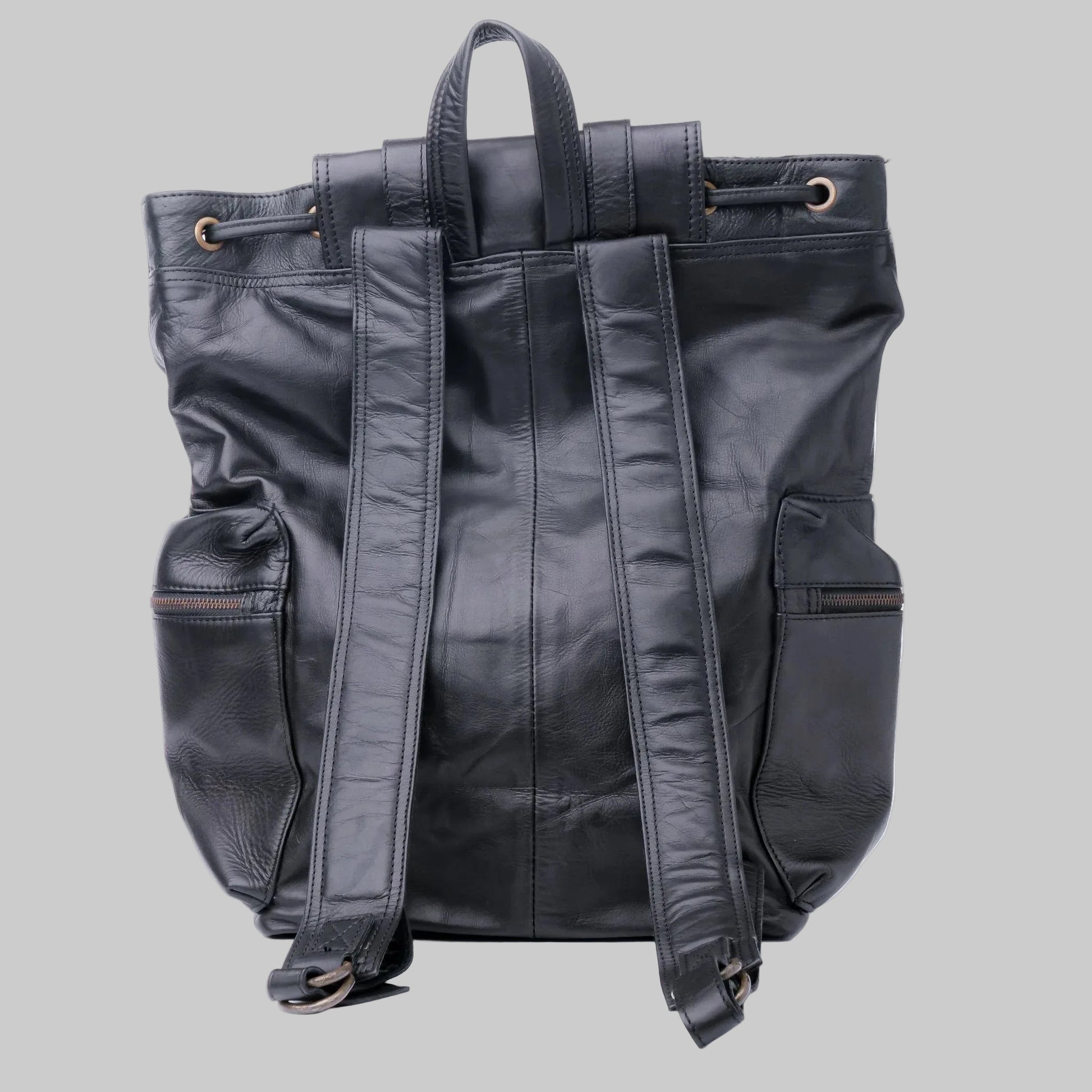 Black leather backpack shown from the back, featuring dual top handles, side pockets, and padded shoulder straps, photographed against a plain white background.