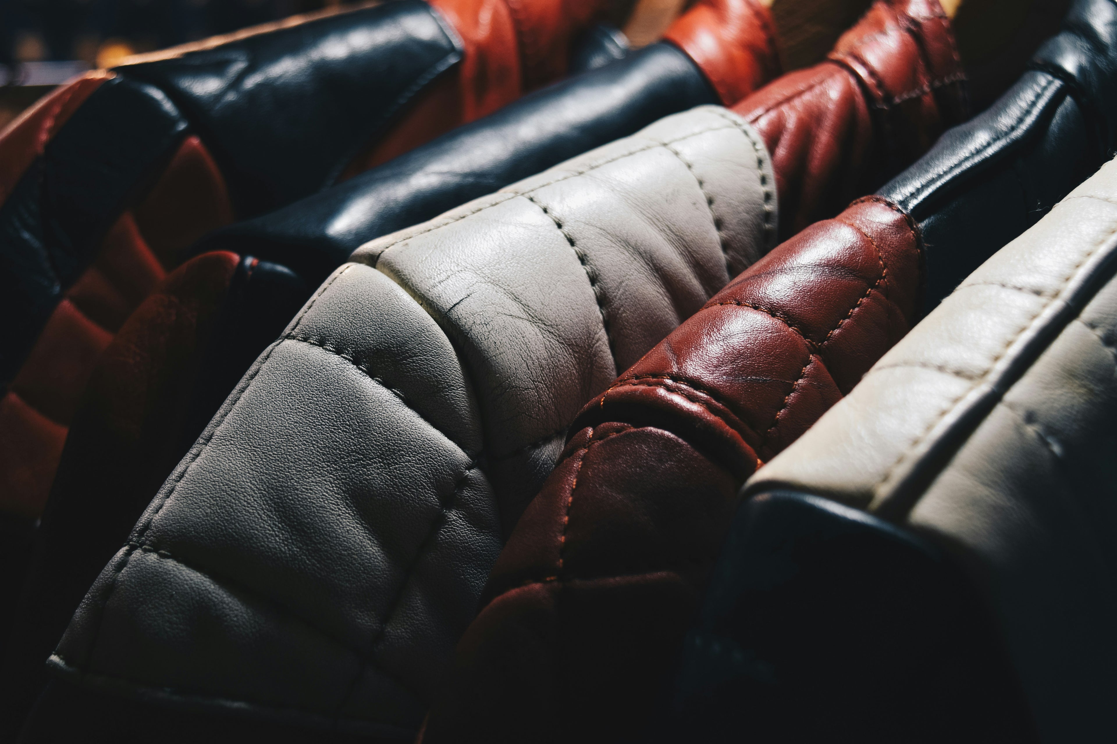 Close-up of leather jackets in various colors.